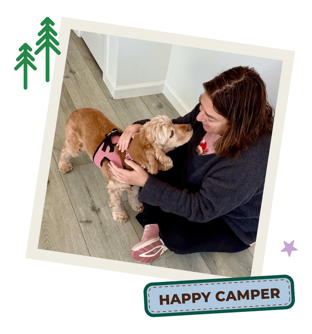 Cathy with a Cocker Spaniel, with the text "Happy Camper"